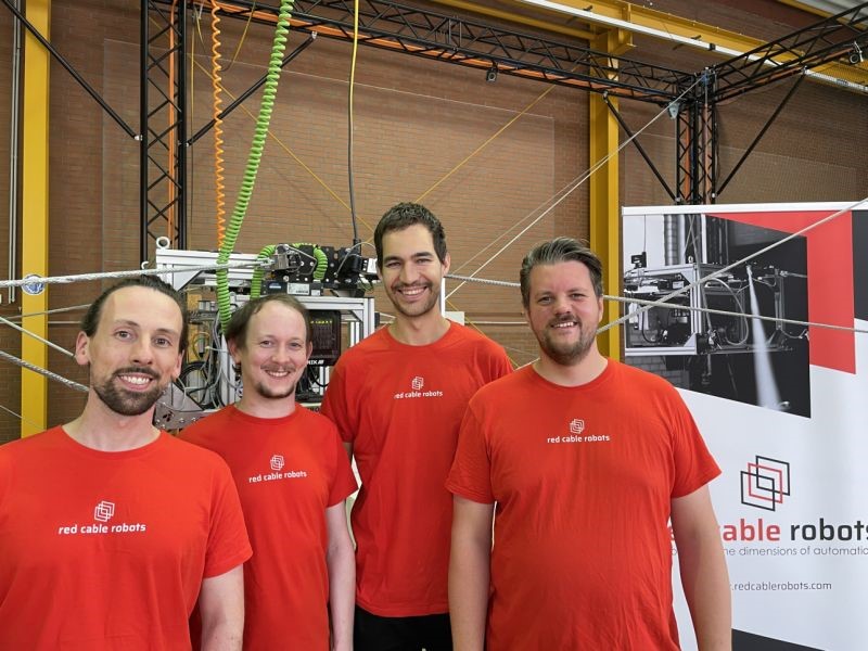 four men in red t-shirts